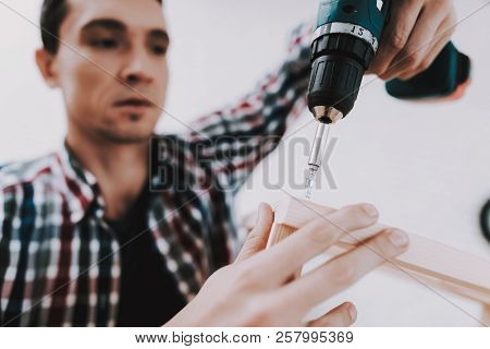Young Man Assembling Wooden Bookshelf At Home. Wooden Bookcase. Selfmade Furniture. Man And Hobby. W