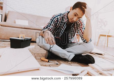 Young Man Assembling Wooden Bookshelf At Home. Wooden Bookcase. Selfmade Furniture. Man And Hobby. W