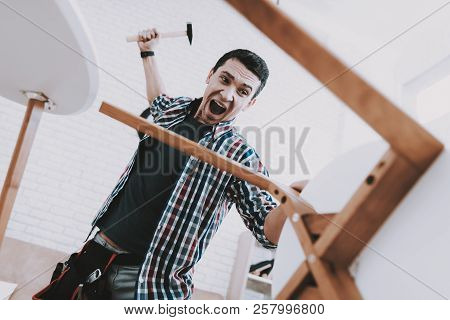 Young Man Assembling Coffee Table And Stools. Furniture Fittings. Engineer With Tool. Young Man At H