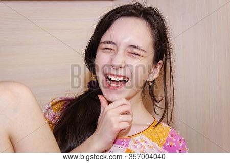 The Girl Laughs Very Much, Closing Her Eyes. Nicker.