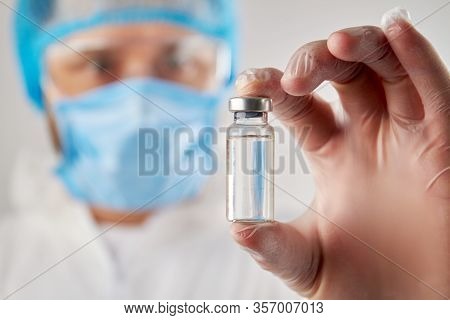 Doctors Hand Holding A Vial Of Clear Liquid For Injection. Close Up Transparent Bottle Ampulas Fille