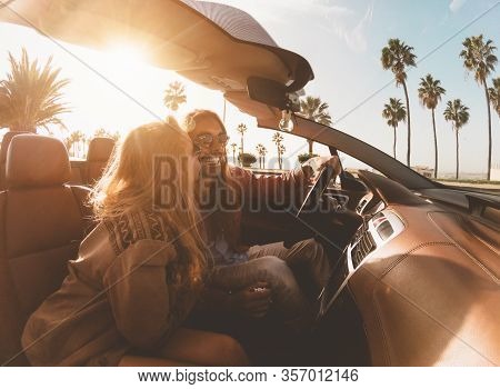 Happy Young Couple Doing Road Trip In Tropical City - Travel People Having Fun Driving In Trendy Con