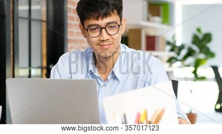 Asian Office Man Concentrate On Working With Laptop Computer At Office, Young Businessman Comtemplat