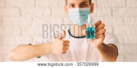Banner Confident Doctor In Protective Mask On Face Holding Sanitizer Bottle In Hand And Showing Like