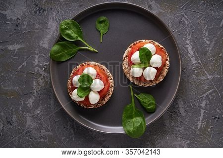 Toasts With Mozzarella, Tomatoes And Spinach In A Gray Plate