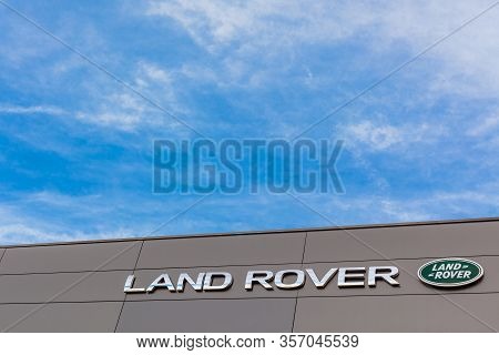 Land Rover Brand Logo On Bright Blue Sky Background Located On Its Dealer Office Building In Lyon, F