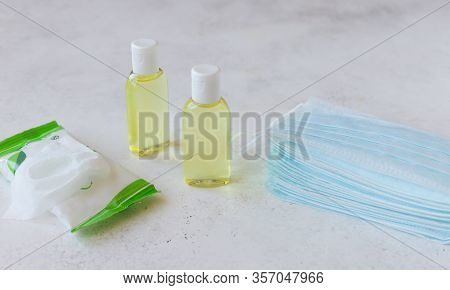Protective Medical Masks, Bottles With Liquid Antiseptic And Antibacterial Wipes. Safe Medical Means