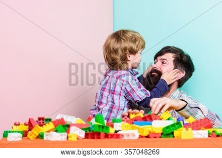 Surefire Ways To Bond With Your Son. Father Son Game. Dad And Kid Build Plastic Blocks. Child Care D