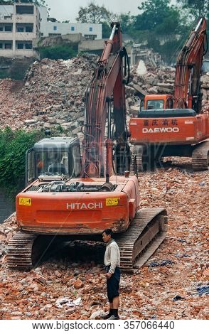 Chongqing, China - May 9, 2010: Downtown, Off Peoples Square. Red Daewoo And Hitachi Demolition Cran