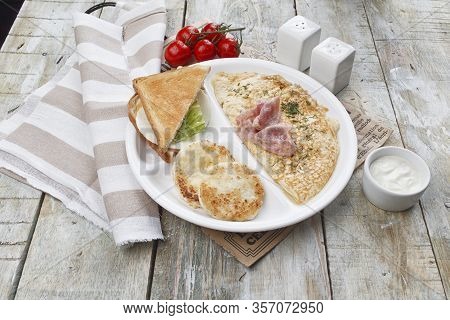 Breakfast Omelet With Bacon. Pancakes, Sandwich. On A Wooden Table
