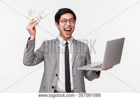 Waist-up Of Excited, Lucky Handsome Rich Asian Guy, Entrepreneur Got His First Money, Selling Or Inv