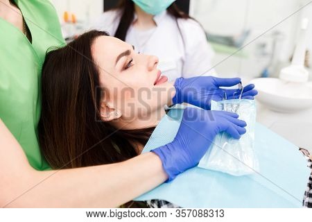 Dentist Doctor Removes Sterile Instruments From A Bag