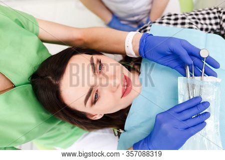 Dentist Doctor Removes Sterile Instruments From A Bag