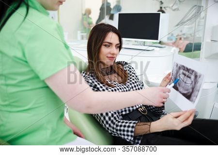 Dentist Doctor Shows An X-ray Of The Oral Cavity To His Patient
