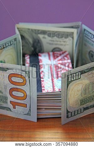 Hundred Dollar Notes And Credit Cards. Stack Of Credit Cards Fenced In Dollars. Cash And Non-cash Mo