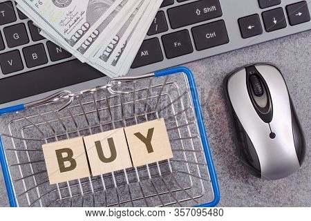 Dollar Banknotes On Keyboard And Shoppng Basket With Buy Text. Online Shopping Concept.
