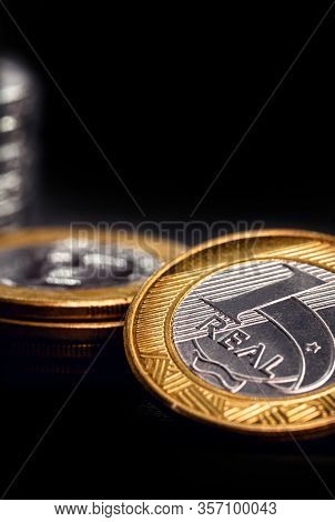 One Real Coins Isolated On Black Background. Money From Brazil. Brazil Economy Or Financial Crisis C