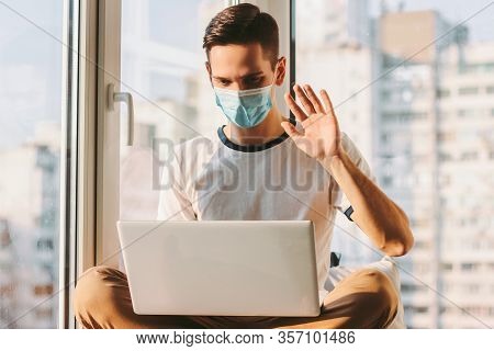 Student Freelancer Having Online Business Meeting And Sitting On Windowsill. Young Businessman In Me