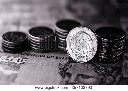 Image Of Money From Brazil, Banknotes Of 100 Reais And Coins, With Contrast And Shadows. Concept Of