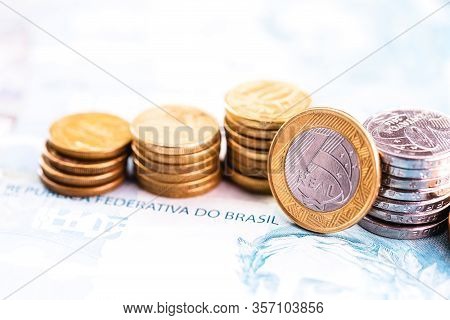 One Real Coin And Gold Bars. Concept Of Appreciation Of The Brazilian Currency In The Stock Market.