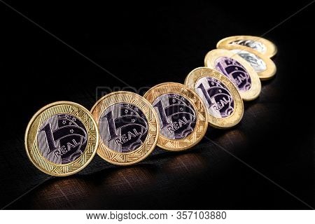 Images Of One Real Coins, Money From Brazil On Isolated Black Background. Falling Real Of The Brazil