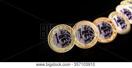 Images Of One Real Coins, Money From Brazil On Isolated Black Background. Falling Real Of The Brazil