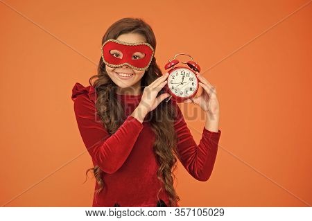 Winter Carnival. Masquerade Concept. Kid Wear Eye Mask. Girl Wear Mask Orange Background. Winter Eve