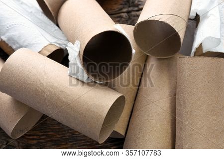 A Close Up Image Of Several Empty Brown Toilet Tissue Rolls.