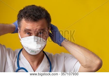 Medical Worker Wearing Medical Masck On Yellow Background