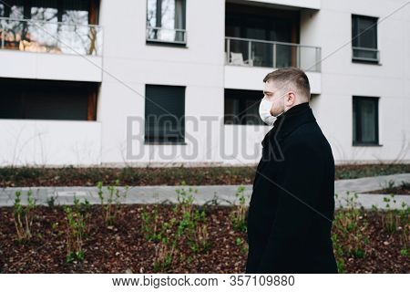 Young Handsome Man Walking In A Residential Area During Covid-19 Coronavirus Global Epidemic, In Qua