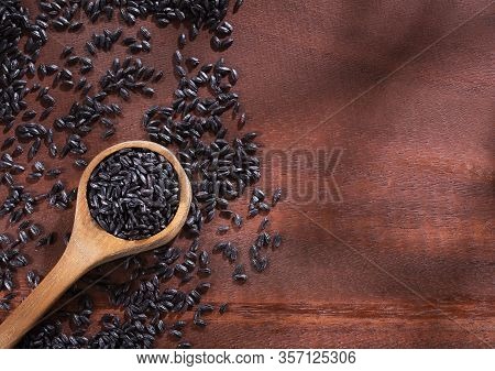 Black Rice In Wooden Spoon - Oryza Sativa