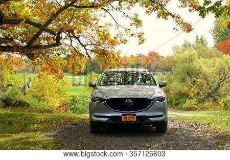 Wellesley Island, New York, U.s.a - October 25, 2019 - A Silver Mazda Cx-5 Suv Surrounded By Fall Fo