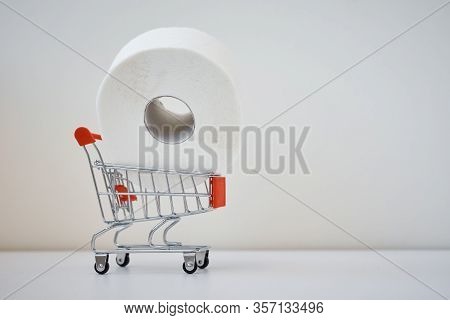 Consumer Buying Panic About Coronavirus Covid-19 Concept. Toilet Paper Roll In A Shopping Trolley Wi