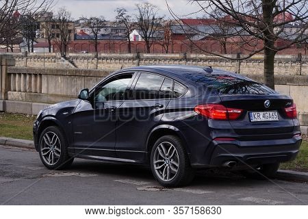 Krakow, Poland 23.02.2020: Black Bmw X4 Expensive German Car On A City Street . Parking On The Road.