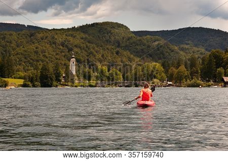 Girl Kayaking In The Scenic Bohinj Lake, Slovenia