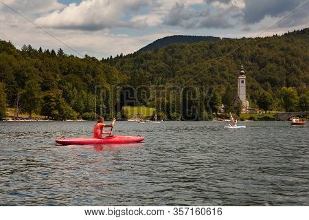 Girl Kayaking In The Scenic Bohinj Lake, Slovenia