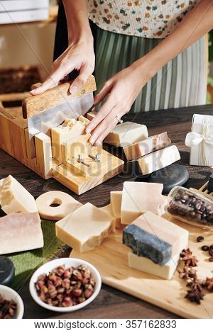 Woman Cutting Handmade Fragrant Soap Into Small Bars With Sharp Knide In Special Mold