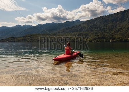 Girl Kayaking In The Scenic Bohinj Lake, Slovenia