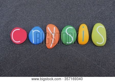 Crysis Word Composed With Multi Colored Stone Letters Over Black Volcanic Sand