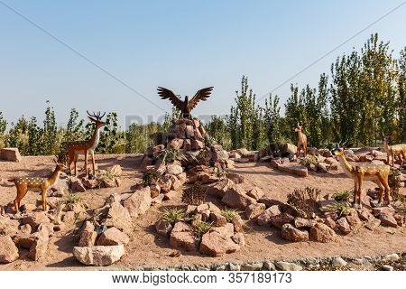 Katta Turk, Uzbekistan - October 18, 2019: Statue Of Sika Deer And Eagle On A Mountain Of Stones On 