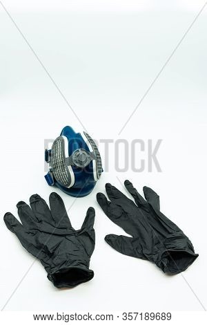 Vertical View Of Black Nitrite Gloves And Coronavirus Mask Isolated On A White Background Pandemic C