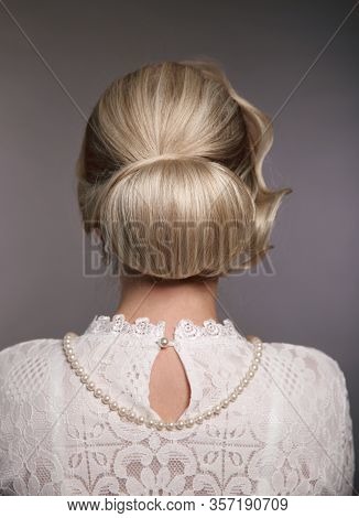 Wedding Hairstyle. Portrait Of Retro Woman With Shiny Wavy Bundle Hair, Feather In Head. Back View O