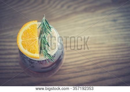 Glass Of Espresso Shot Mixed With Orange Juice On Wood Table. Refreshing Summer Drink Concept