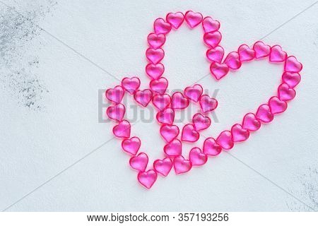 Two Pink Hearts Made Of Plastic Hearts