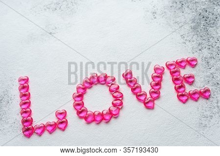 The Word Love Made Of Small Hearts. View From Above
