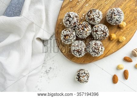 Coconut And Nuts Balls On A Wooden Board Top View