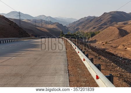 A 373 Tashkent Osh Highway In Uzbekistan. Iron Fence On A Mountain Road