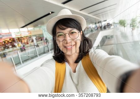 Portrait Of Young Woman Traveler Wear Glasses And Hat Taking Selfie. Happy Smiling Girl Passenger. J