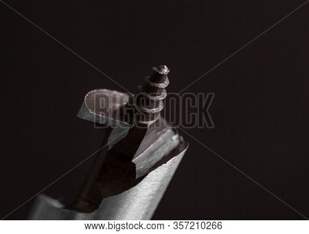 Shank Drill Close-up. Drill For Woodwork. Spiral Drill. Spiral Steel Drill On A Dark Background. Fra
