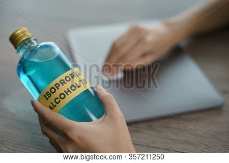 Hand With Isopropyl Alcohol For Clean Laptop , Corona Virus Or Covid-19 Protection.